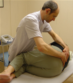 Manipulating the spine of a patient to alleviate back pain at one of the osteopath clinics
